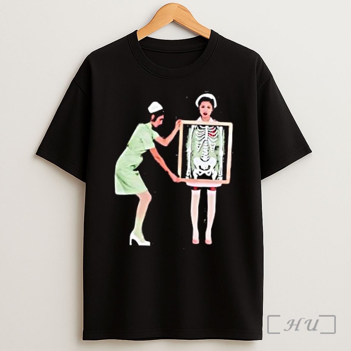 Officials Nurse Holding Xray Of Skeleton With Red Heart In Front Of Another Nurse Shirt